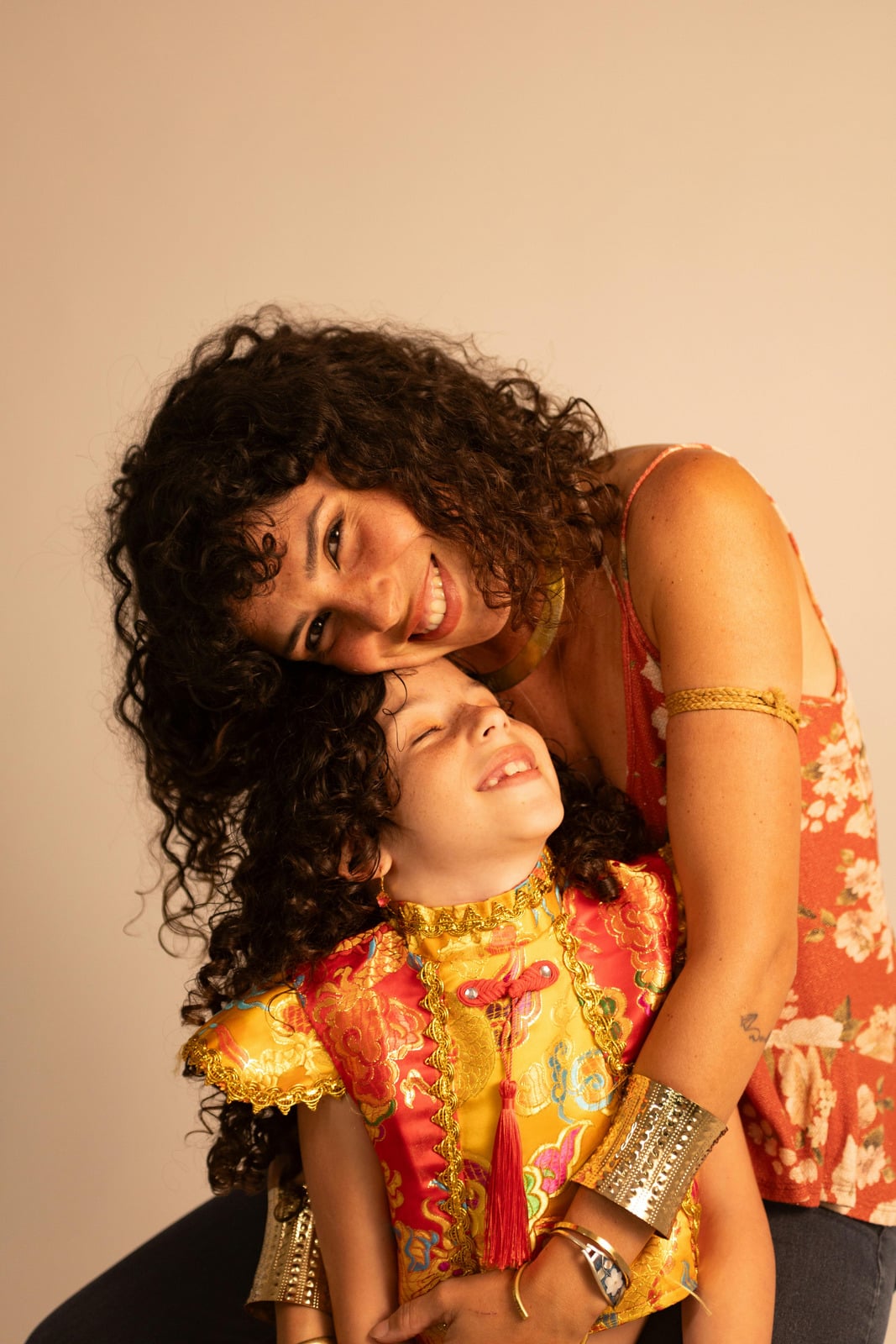 A mother and her young daughter laughing together